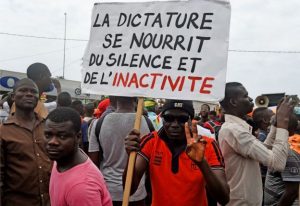 A protestor holds up a sign exhorting opposition against dictatorship in Togo (West - Africa) in 2017